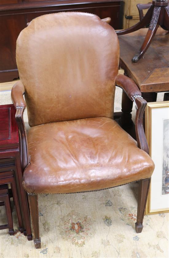 An oak and leather elbow chair